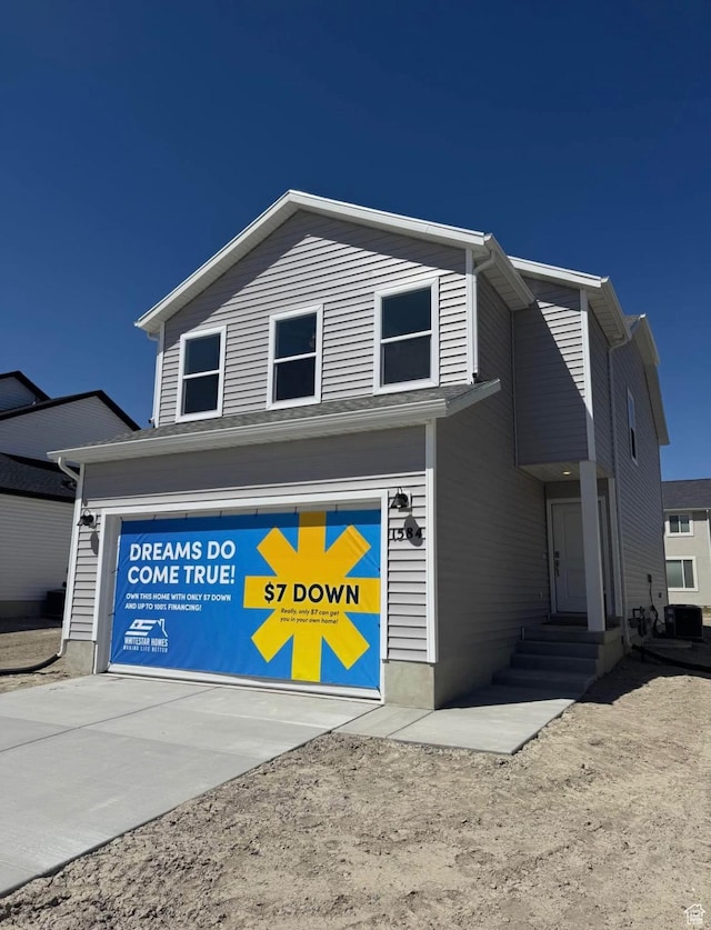 1584 E Pheasant Rd S Unit 210, Eagle Mountain, UT 84005 - view of front of home featuring entry steps, an attached garage, driveway, and central air condition unit