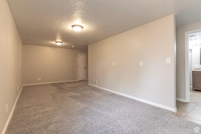 1608 W 8470 S, West Jordan, UT 84088 - unfurnished room featuring baseboards, a textured ceiling, and light colored carpet