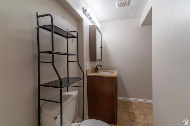 1608 W 8470 S, West Jordan, UT 84088 - half bathroom with stone finish floor, toilet, vanity, baseboards, and visible vents