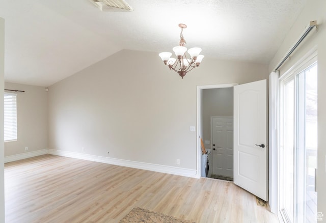 1608 W 8470 S, West Jordan, UT 84088 - empty room with a chandelier, plenty of natural light, light wood-style flooring, and vaulted ceiling
