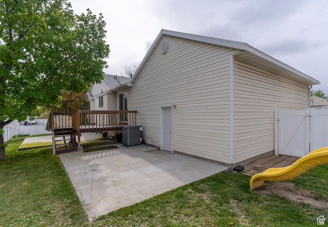 1608 W 8470 S, West Jordan, UT 84088 - view of home's exterior featuring cooling unit, a patio, a wooden deck, fence, and a yard