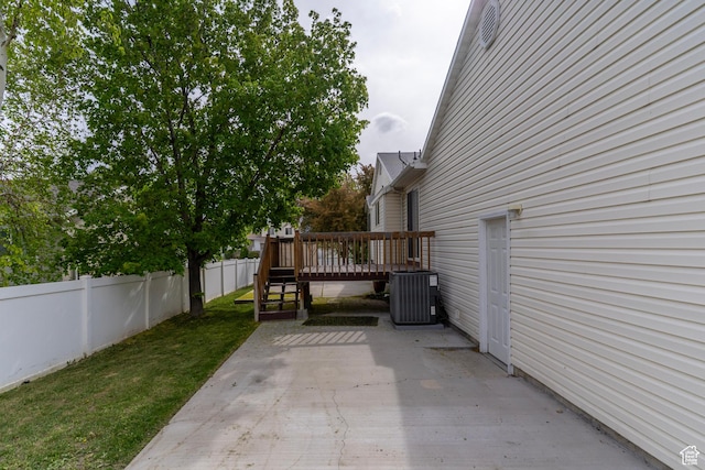 1608 W 8470 S, West Jordan, UT 84088 - view of property exterior with a patio, a wooden deck, a fenced backyard, a lawn, and central AC