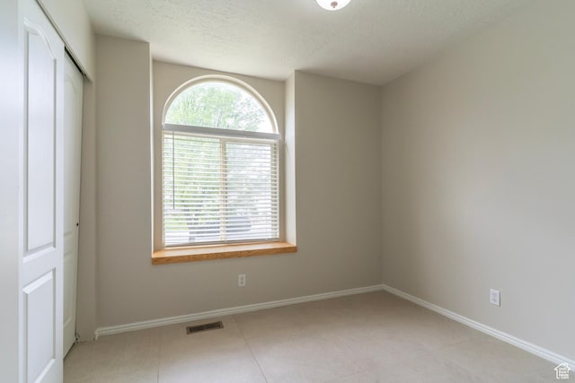 1608 W 8470 S, West Jordan, UT 84088 - unfurnished bedroom featuring baseboards, visible vents, a textured ceiling, and a closet