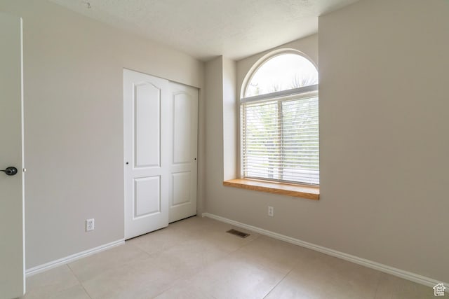 1608 W 8470 S, West Jordan, UT 84088 - unfurnished bedroom with light tile patterned floors, visible vents, and baseboards