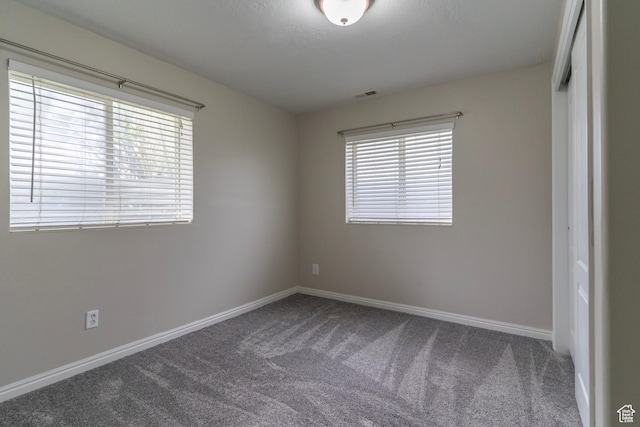 1608 W 8470 S, West Jordan, UT 84088 - unfurnished bedroom featuring baseboards, visible vents, carpet floors, and multiple windows