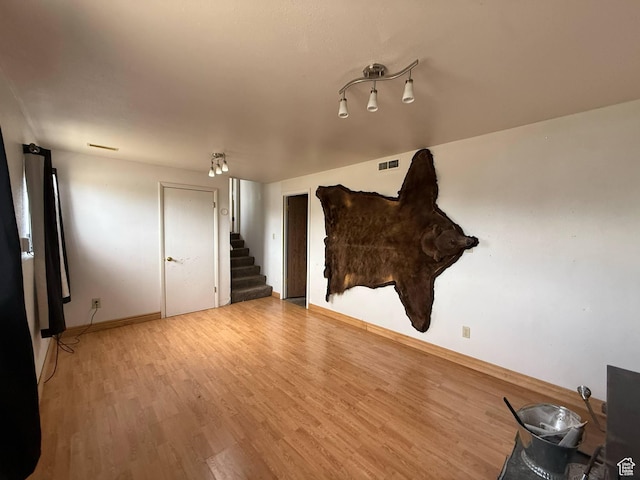 35 E 970 N, Castle Dale, UT 84513 - unfurnished living room featuring wood finished floors, baseboards, visible vents, and stairs