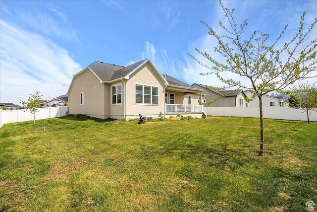 3339 W 650 N, Layton, UT 84041 - rear view of house featuring stucco siding, a yard, and a fenced backyard