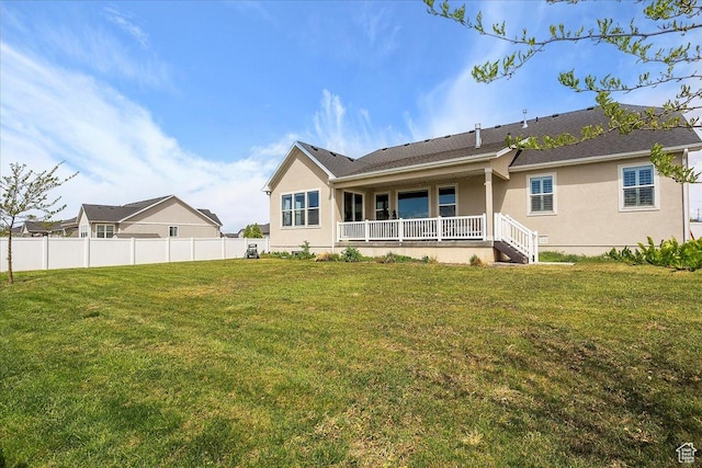 3339 W 650 N, Layton, UT 84041 - back of property featuring covered porch, fence, stucco siding, and a lawn