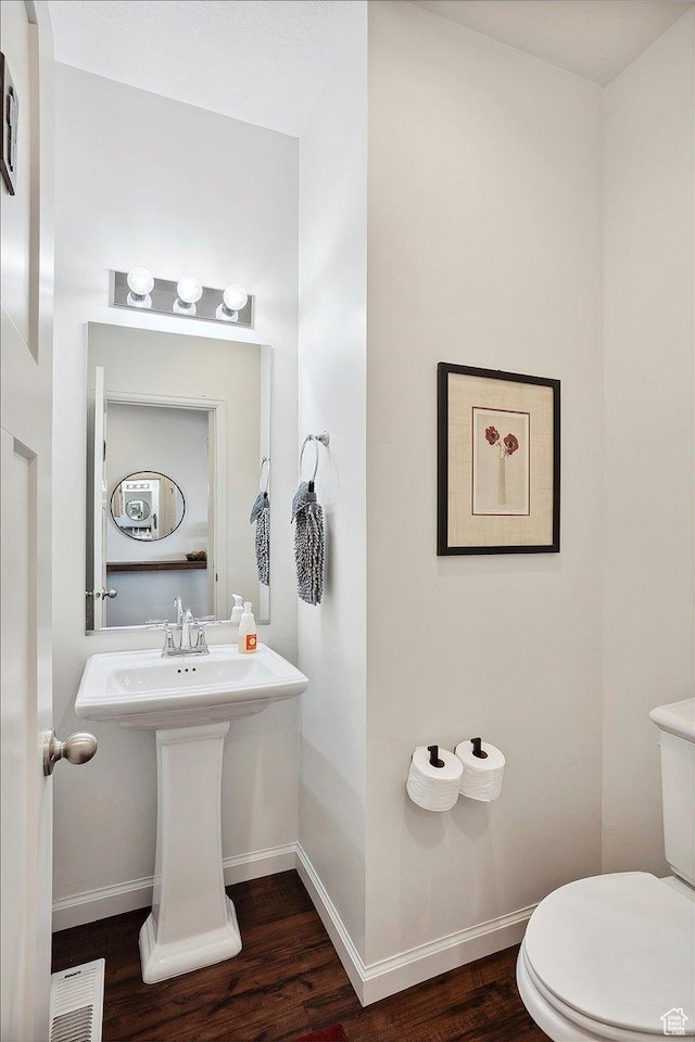 3339 W 650 N, Layton, UT 84041 - bathroom with wood finished floors, toilet, visible vents, and baseboards