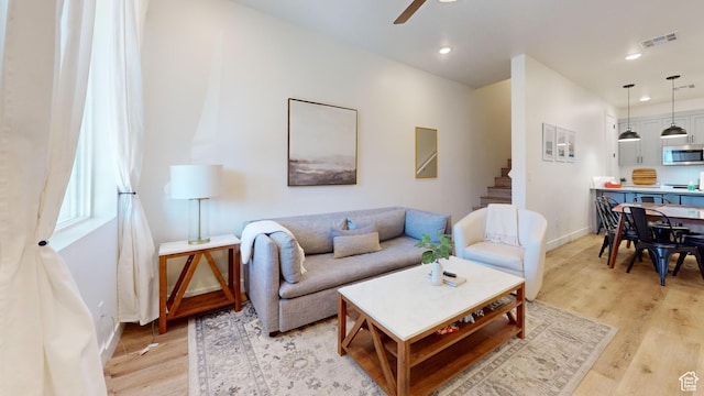 5399 S Cerulean Ln Unit 98, St George, UT 84790 - living room featuring baseboards, visible vents, ceiling fan, and light wood-type flooring