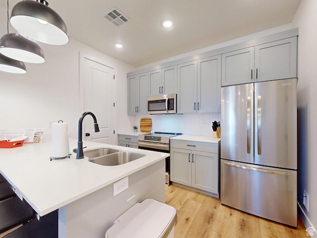 5399 S Cerulean Ln Unit 98, St George, UT 84790 - kitchen featuring appliances with stainless steel finishes, light countertops, a kitchen breakfast bar, and a sink