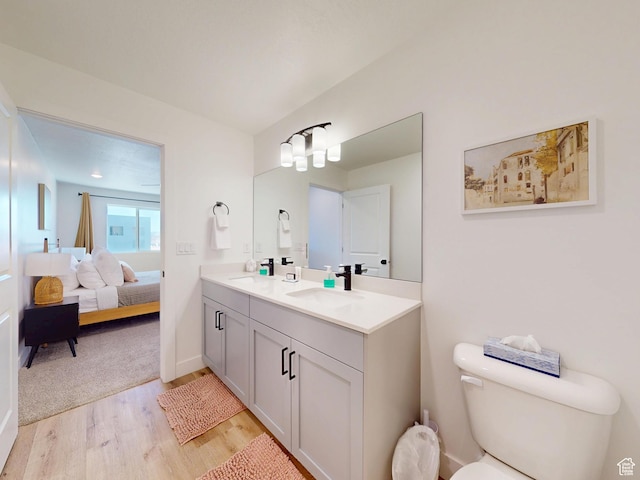 5399 S Cerulean Ln Unit 98, St George, UT 84790 - ensuite bathroom featuring wood finished floors, double vanity, toilet, ensuite bathroom, and a sink