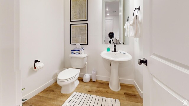 5399 S Cerulean Ln Unit 98, St George, UT 84790 - half bathroom featuring baseboards, wood finished floors, and toilet