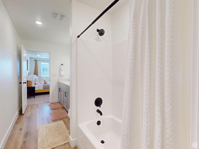 5399 S Cerulean Ln Unit 98, St George, UT 84790 - bathroom with baseboards, wood finished floors, shower / bath combination with curtain, and ensuite bathroom