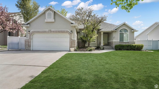 ranch-style home with stucco siding, fence, driveway, and a front yard