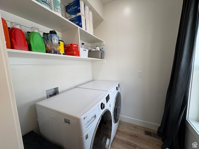 4460 Fawn Way Unit 2039, Heber City, UT 84032 - clothes washing area with laundry area, baseboards, wood finished floors, visible vents, and washing machine and dryer