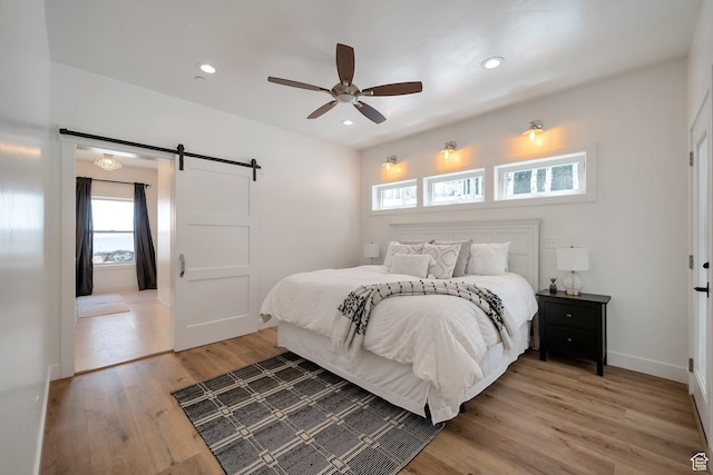 4460 Fawn Way Unit 2039, Heber City, UT 84032 - bedroom featuring light wood-style floors, a barn door, baseboards, and recessed lighting