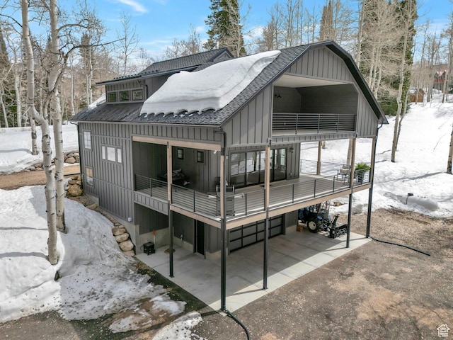 4460 Fawn Way Unit 2039, Heber City, UT 84032 - snow covered back of property with board and batten siding, a shingled roof, and a balcony