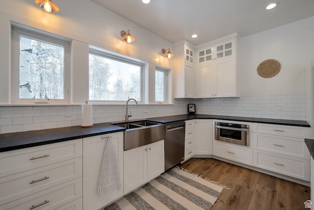 4460 Fawn Way Unit 2039, Heber City, UT 84032 - kitchen featuring dark countertops, recessed lighting, white cabinets, a sink, and stainless steel appliances