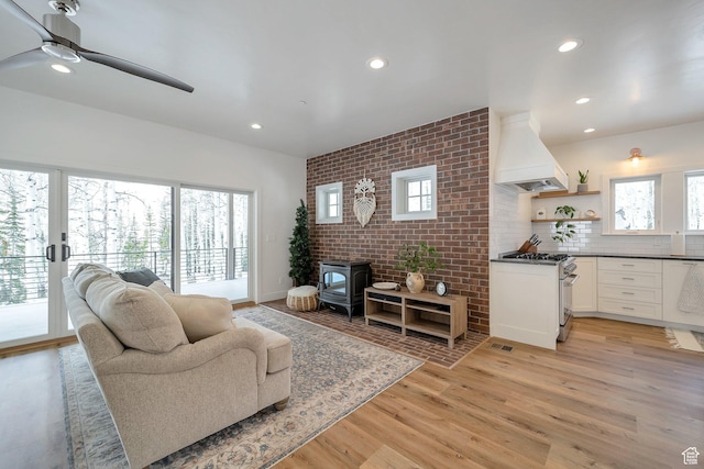 4460 Fawn Way Unit 2039, Heber City, UT 84032 - living room with light wood-style floors, a ceiling fan, a wood stove, and recessed lighting
