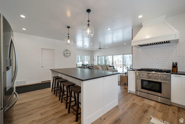 4460 Fawn Way Unit 2039, Heber City, UT 84032 - kitchen featuring premium range hood, dark countertops, appliances with stainless steel finishes, and visible vents