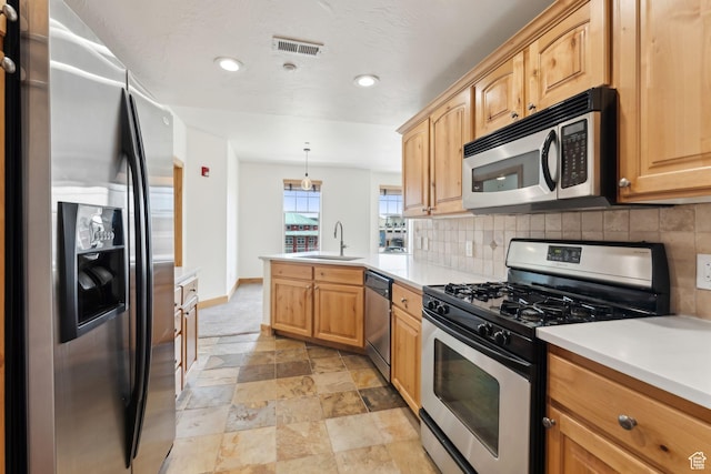 1541 Redstone Ave Unit C, Park City, UT 84098 - kitchen with decorative backsplash, a peninsula, stone finish floor, a sink, and appliances with stainless steel finishes