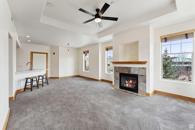 1541 Redstone Ave Unit C, Park City, UT 84098 - unfurnished living room featuring carpet flooring, a ceiling fan, a tray ceiling, and baseboards