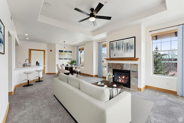 1541 Redstone Ave Unit C, Park City, UT 84098 - carpeted living area featuring ceiling fan, a sink, a tiled fireplace, baseboards, and a tray ceiling