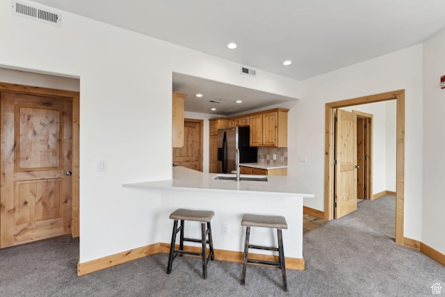 1541 Redstone Ave Unit C, Park City, UT 84098 - kitchen with stainless steel fridge, light carpet, light countertops, a kitchen bar, and visible vents