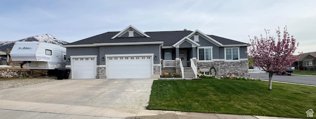 craftsman-style house featuring an attached garage, driveway, stone siding, and stucco siding