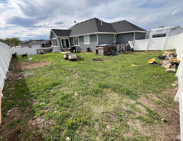 864 E 180 N, Salem, UT 84653 - rear view of property featuring stucco siding, a yard, a shingled roof, and a fenced backyard