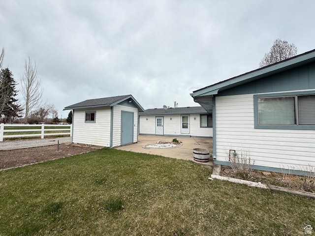1705 S Bear Lake Blvd, Garden City, UT 84028 - back of house featuring an outdoor structure, fence, a shed, a patio area, and a lawn
