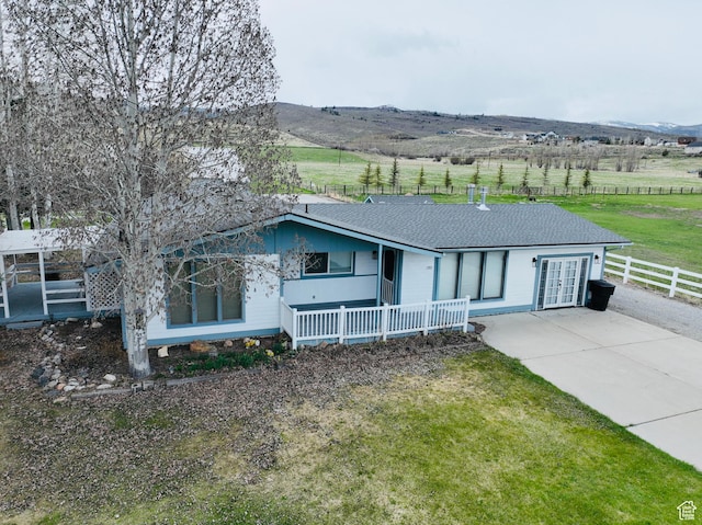 1705 S Bear Lake Blvd, Garden City, UT 84028 - single story home with fence, a front yard, a rural view, french doors, and driveway
