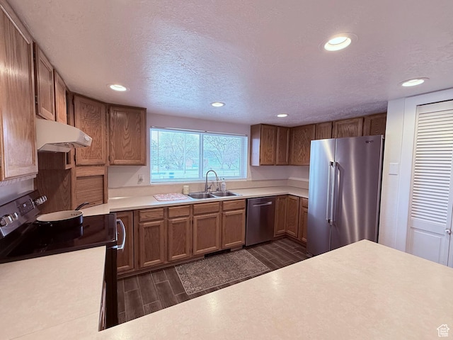1705 S Bear Lake Blvd, Garden City, UT 84028 - kitchen featuring wood finish floors, recessed lighting, under cabinet range hood, a sink, and appliances with stainless steel finishes