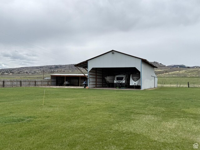 1705 S Bear Lake Blvd, Garden City, UT 84028 - back of house featuring a yard, fence, a pole building, and an outbuilding