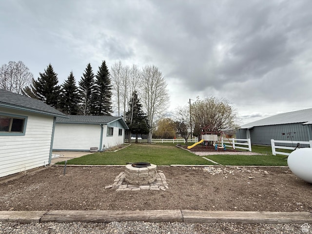 1705 S Bear Lake Blvd, Garden City, UT 84028 - view of yard with a playground, fence, and an outdoor fire pit