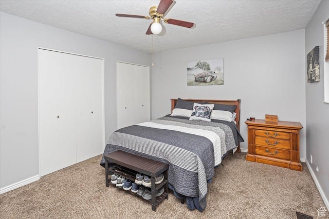 33 S Benchview Dr E, Tooele, UT 84074 - bedroom featuring carpet flooring, a textured ceiling, a ceiling fan, and two closets