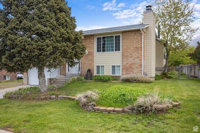 33 S Benchview Dr E, Tooele, UT 84074 - view of front of property with fence, a chimney, brick siding, and a front yard