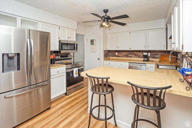33 S Benchview Dr E, Tooele, UT 84074 - kitchen featuring light countertops, decorative backsplash, stainless steel appliances, and a peninsula