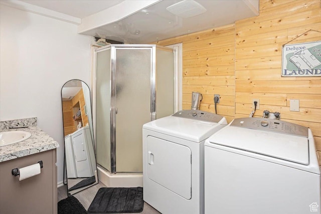 33 S Benchview Dr E, Tooele, UT 84074 - clothes washing area featuring separate washer and dryer, laundry area, and wood walls