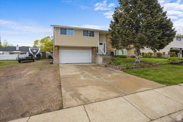 33 S Benchview Dr E, Tooele, UT 84074 - bi-level home with an attached garage, driveway, a front lawn, and brick siding