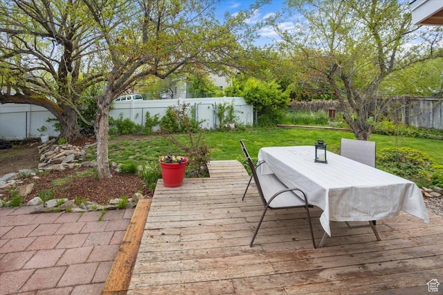 33 S Benchview Dr E, Tooele, UT 84074 - deck featuring a lawn, a fenced backyard, and outdoor dining area