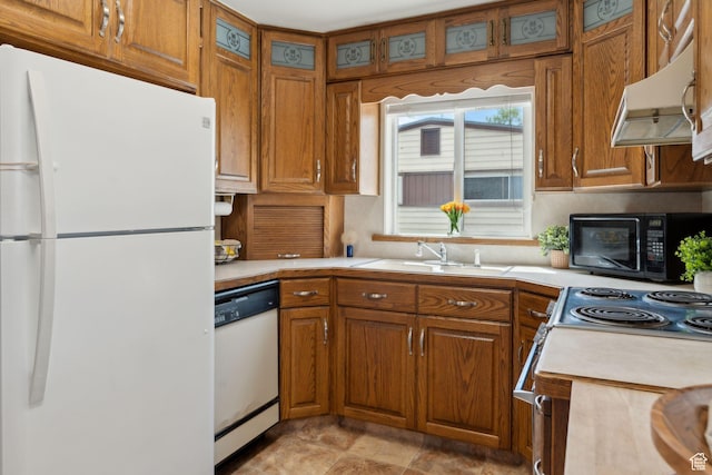 981 N 1300 W, Salt Lake City, UT 84116 - kitchen featuring brown cabinets, a sink, white appliances, light countertops, and under cabinet range hood