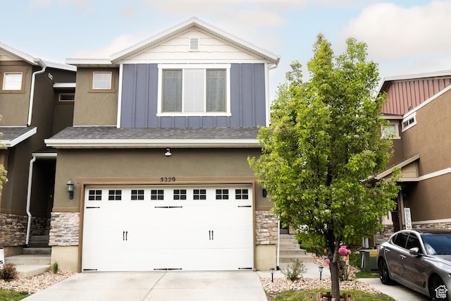 5229 W Armada Way, Herriman, UT 84096 - view of front of home featuring board and batten siding, an attached garage, driveway, and stone siding