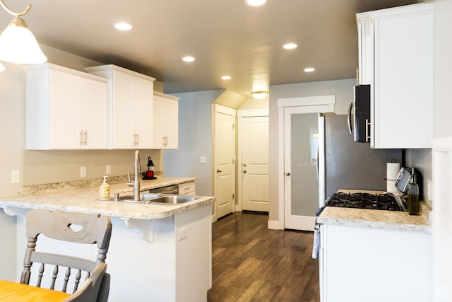 5229 W Armada Way, Herriman, UT 84096 - kitchen featuring white cabinets, a sink, a peninsula, recessed lighting, and dark wood-type flooring