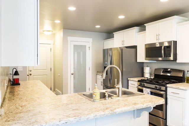 5229 W Armada Way, Herriman, UT 84096 - kitchen with appliances with stainless steel finishes, a sink, recessed lighting, white cabinetry, and visible vents