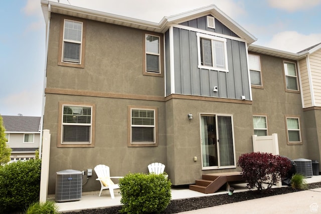5229 W Armada Way, Herriman, UT 84096 - rear view of house with board and batten siding, central AC unit, and stucco siding