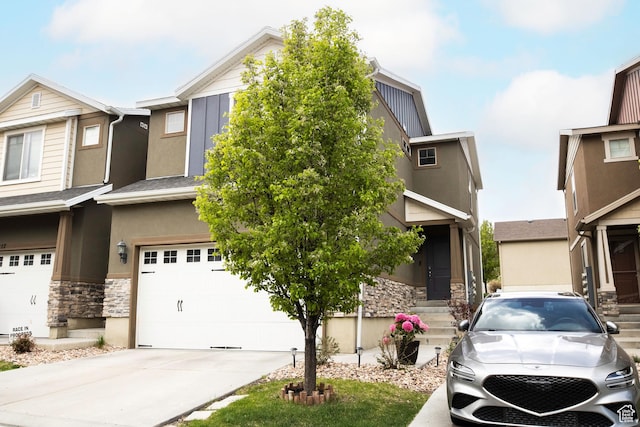 5229 W Armada Way, Herriman, UT 84096 - view of front of property featuring a garage, stucco siding, driveway, and stone siding