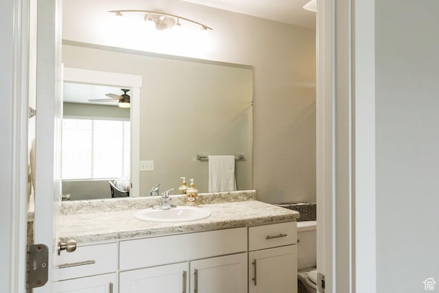 5229 W Armada Way, Herriman, UT 84096 - bathroom featuring a ceiling fan, toilet, and vanity