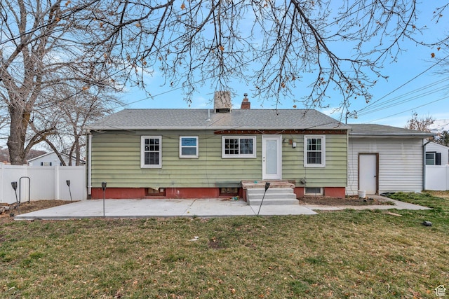 314 Harvard Cir, American Fork, UT 84003 - back of property with a chimney, a lawn, fence, a patio area, and a shingled roof